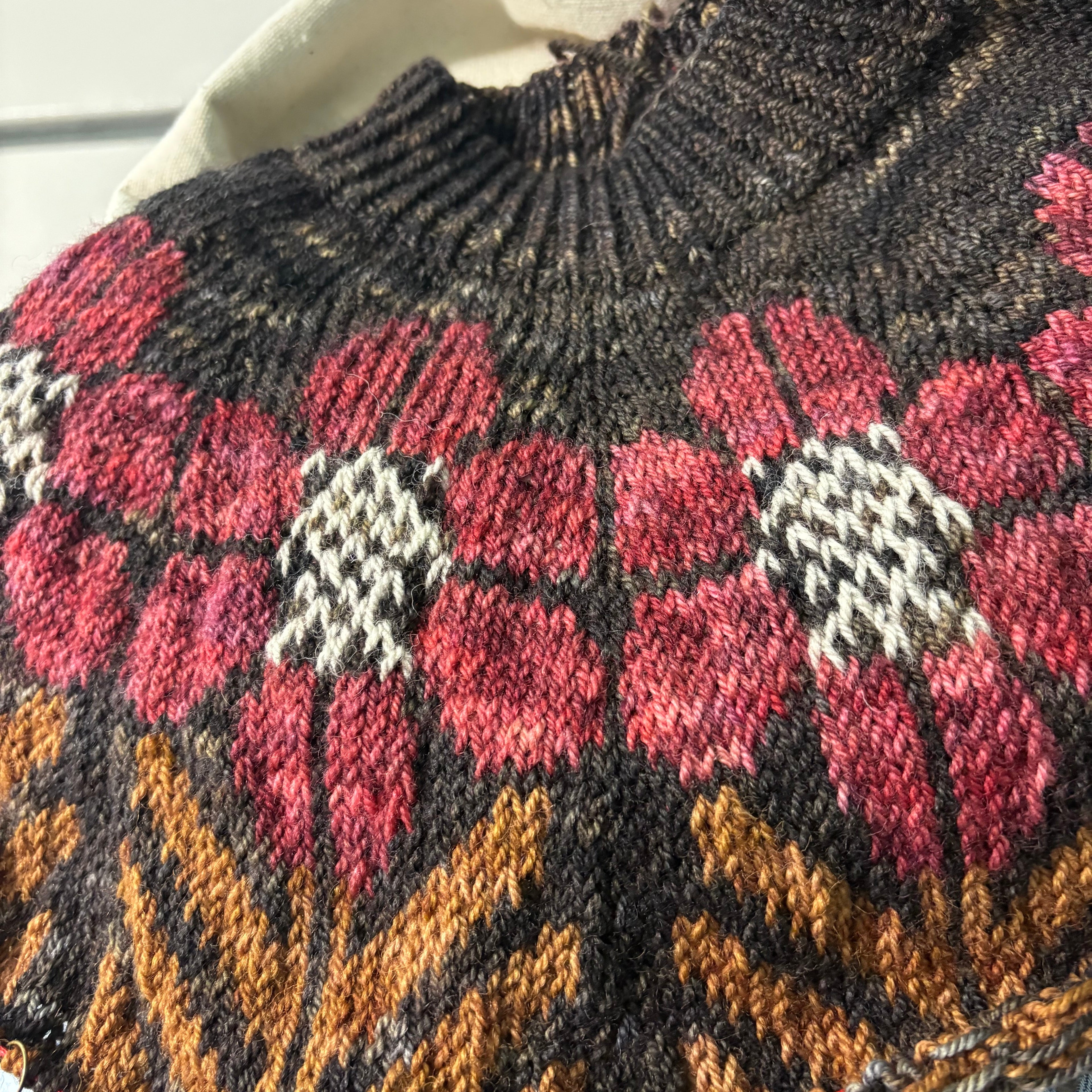 Knit fabric with floral pattern held by a hand