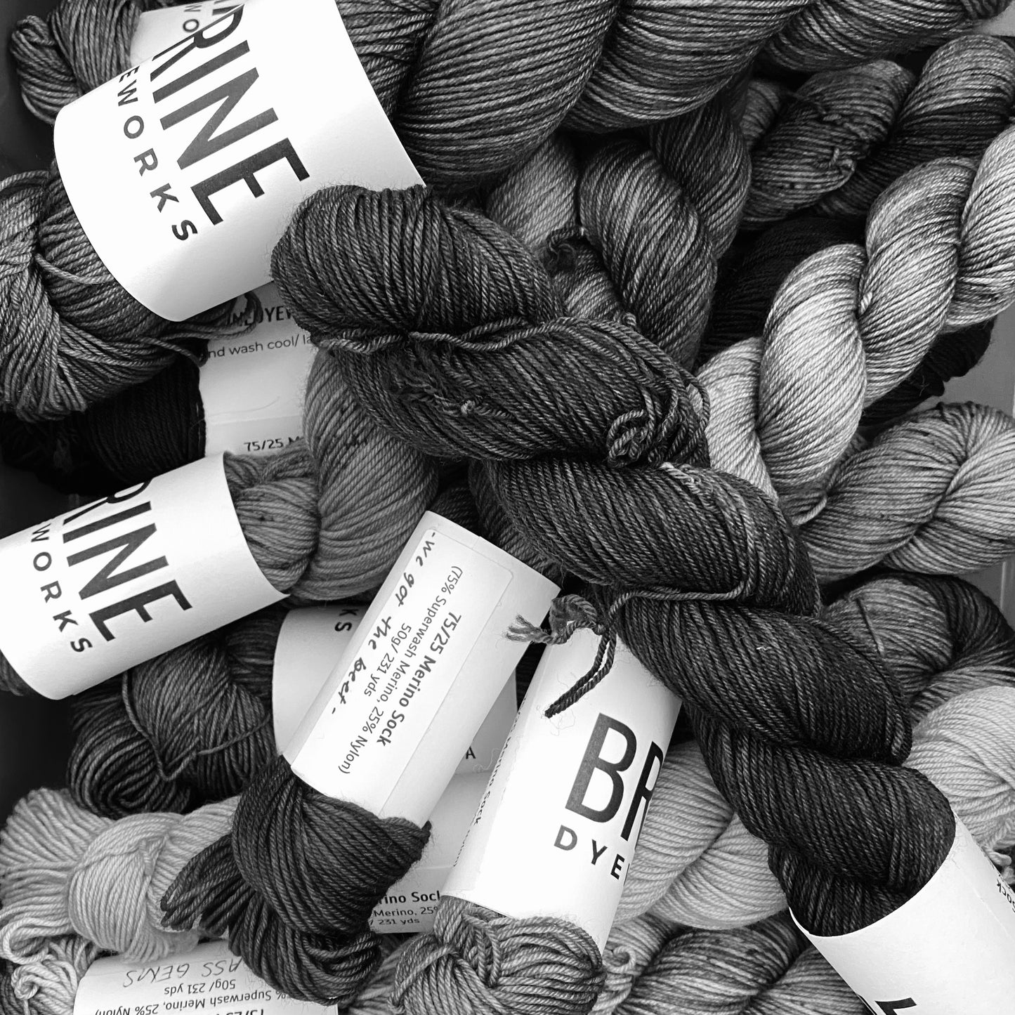a pile of yarn hanks shown in black and white
